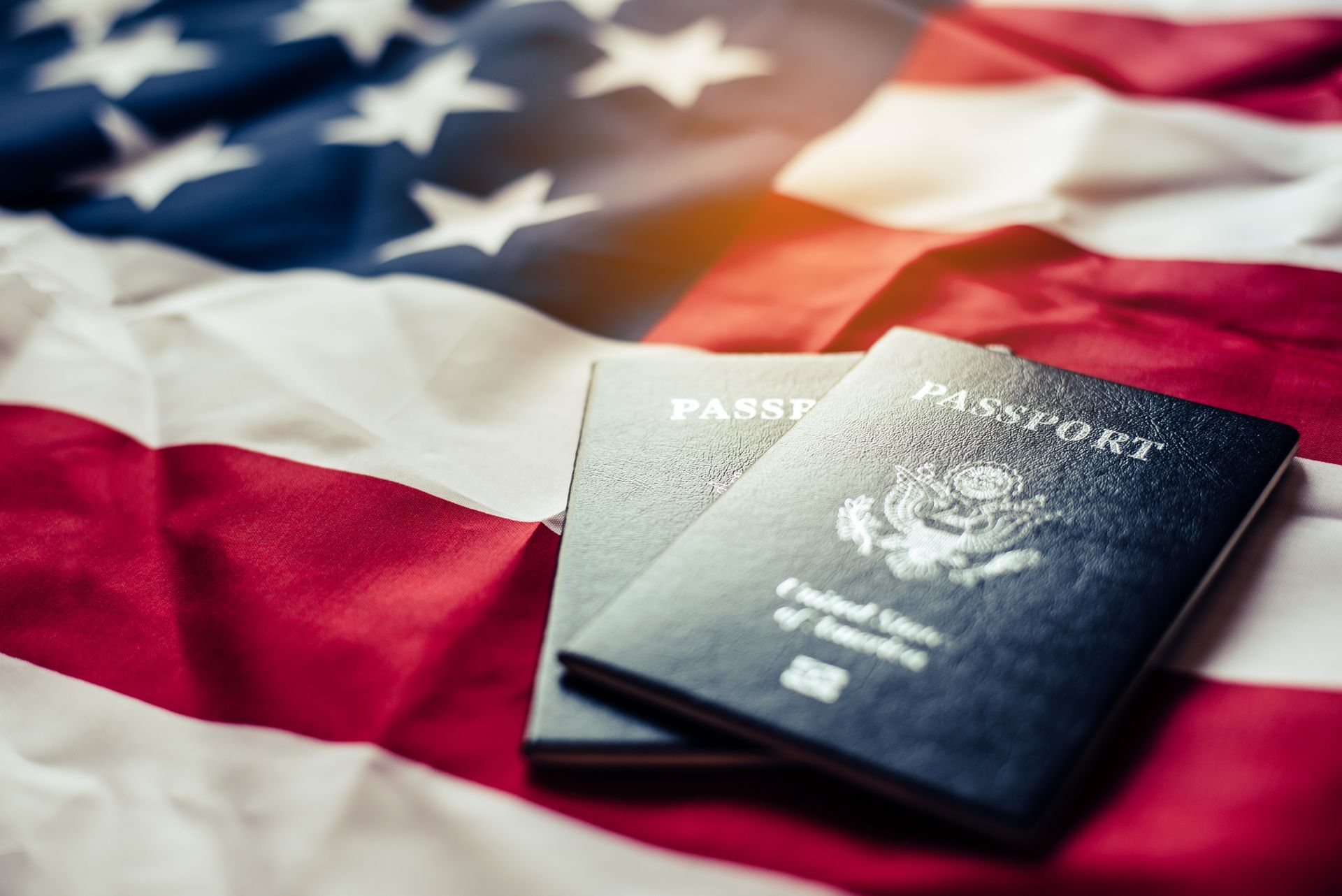 Two U.S. passports on top of the American flag.