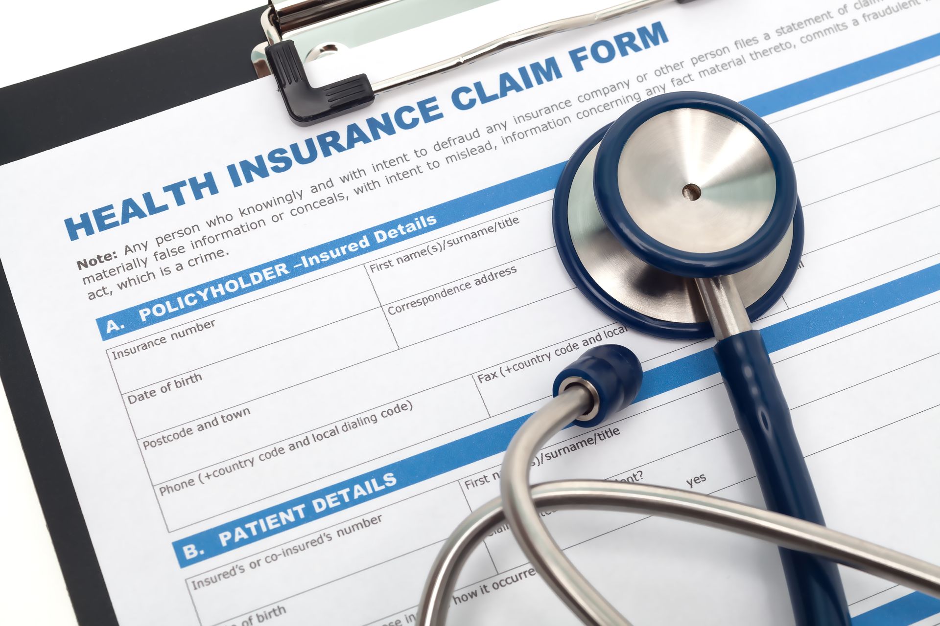 Health insurance claim form with a stethoscope resting on it.