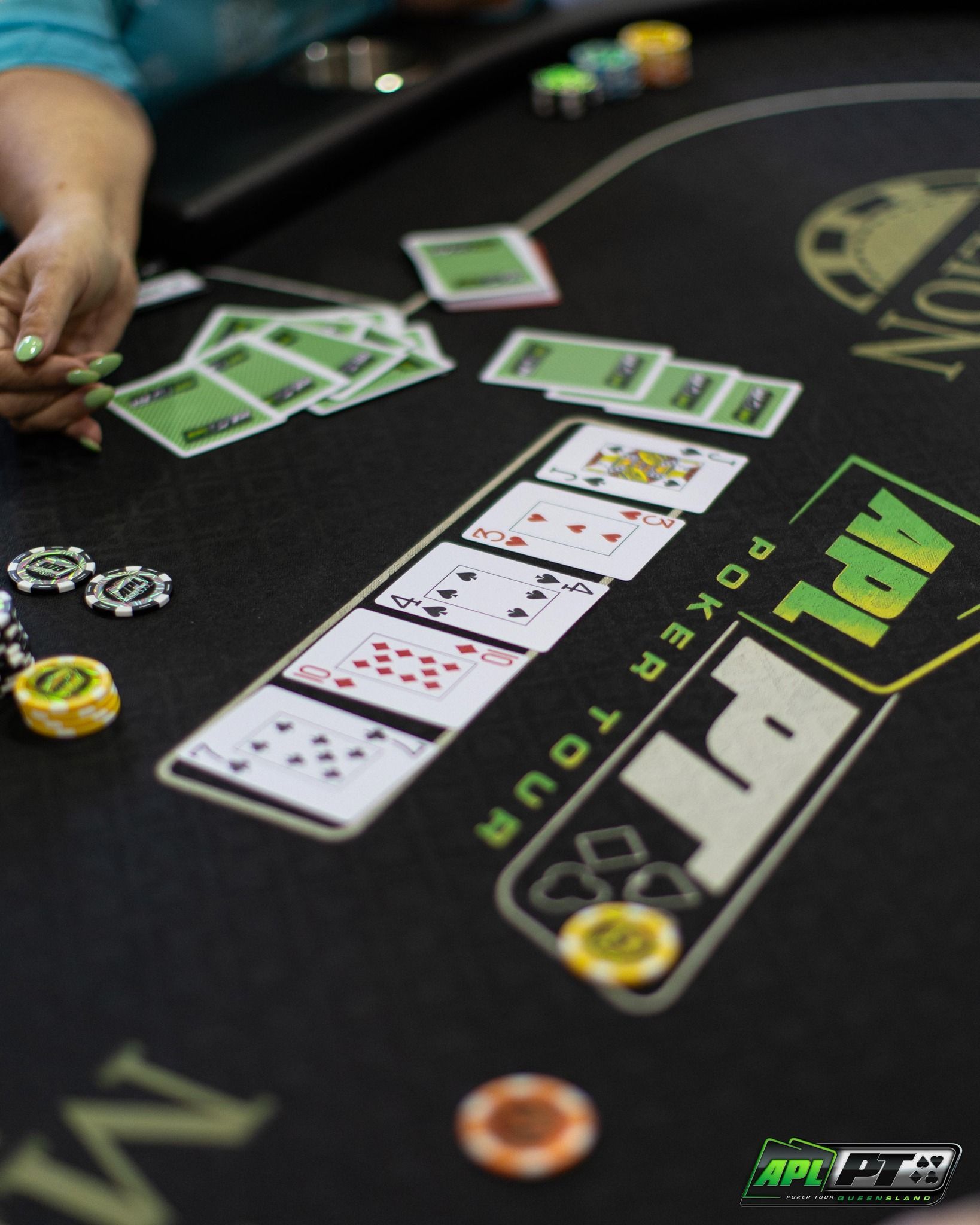 A person is playing poker at an APL poker tour table