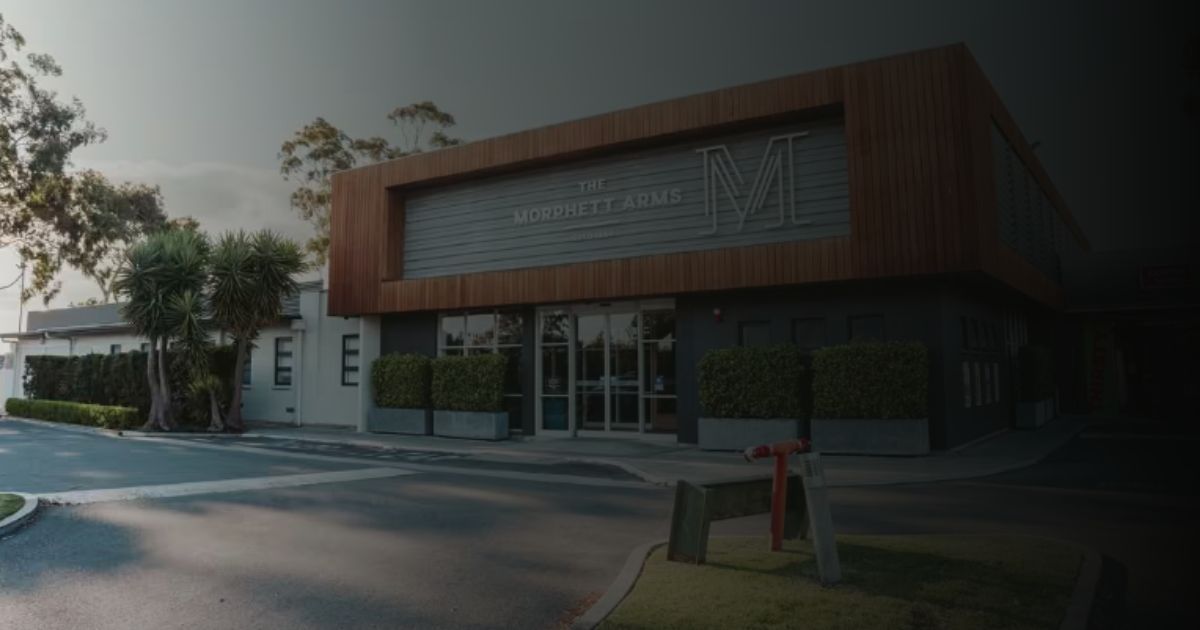 A large building with a red fire hydrant in front of it.