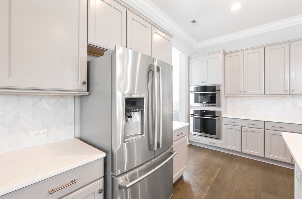 A black kitchenaid mixer with a stainless steel bowl