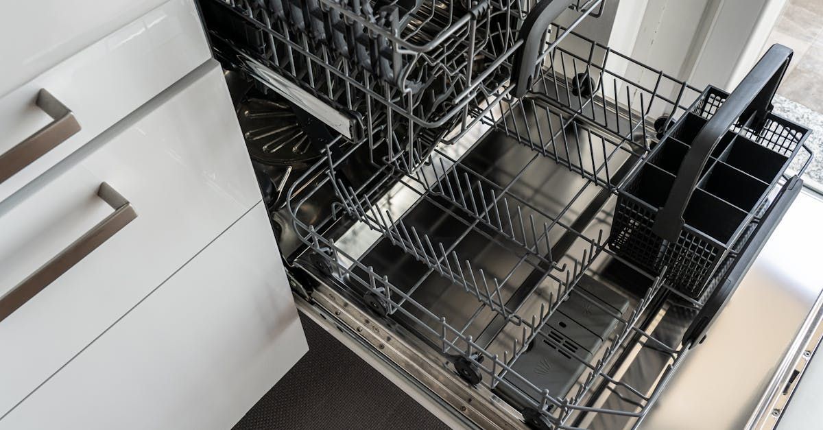 An empty dishwasher is sitting in a kitchen next to a cabinet.