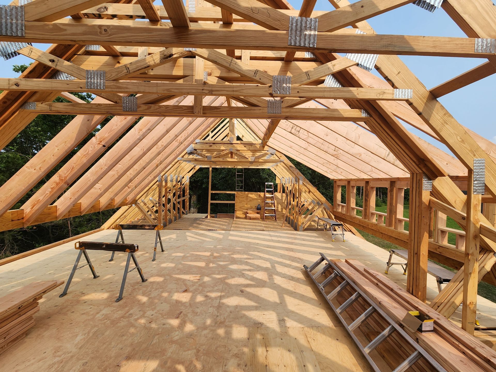 The roof of a house is being built with wooden beams.
