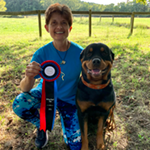 Wonder Dog Training - West Berlin, NJ - A photo of Instructor Ana Cilursu with a dog and holding the award