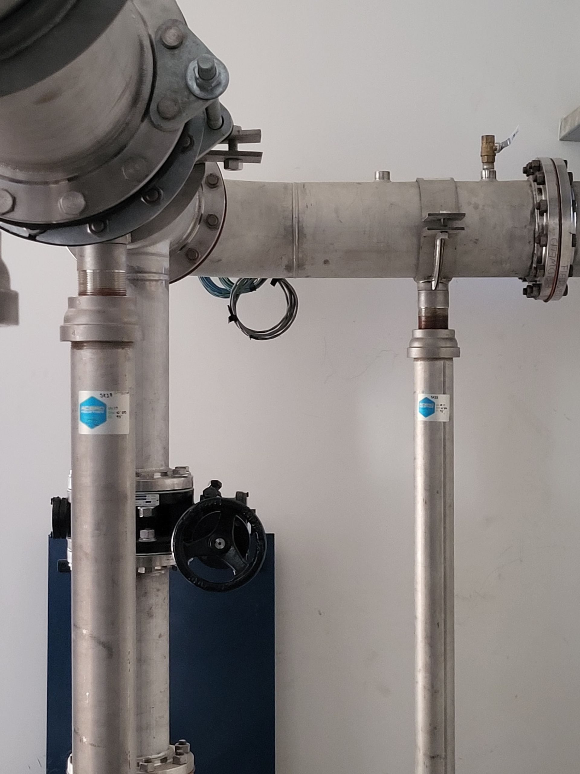  5D Company llc a stainless steel pipe with a blue sticker on it