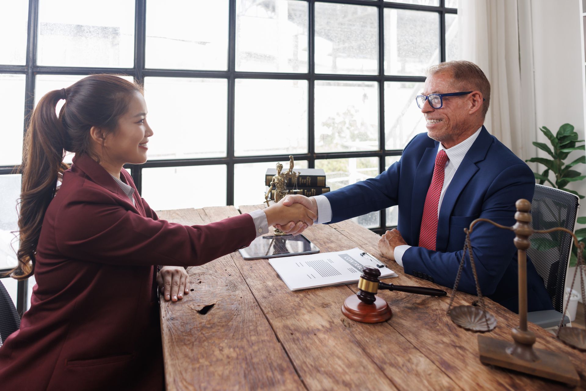 A lawyer is shaking the hand of a woman.