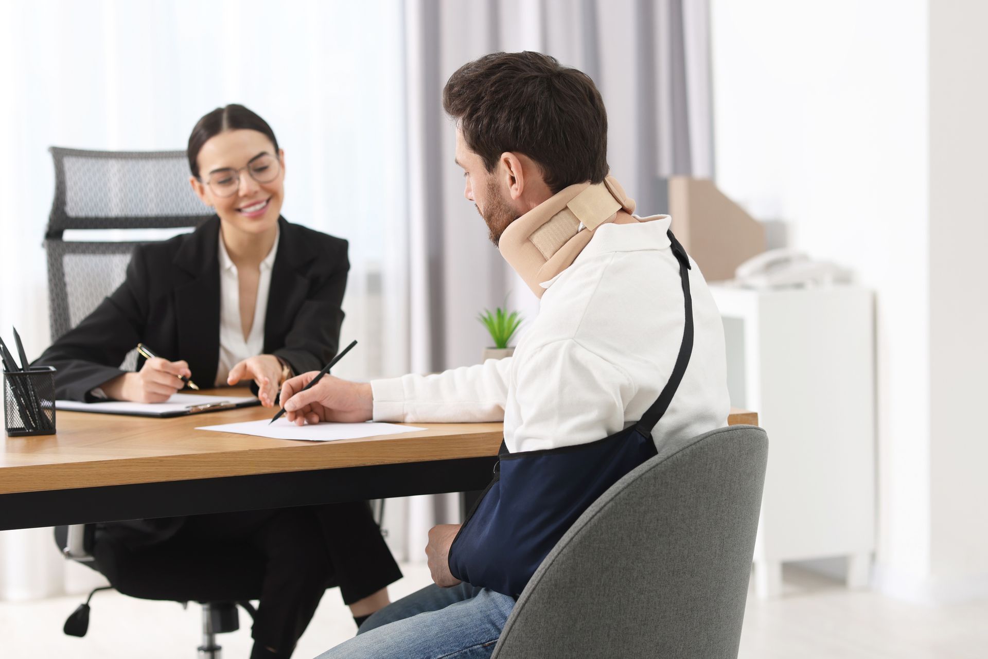 A lawyer is explaining a document to her injured client.