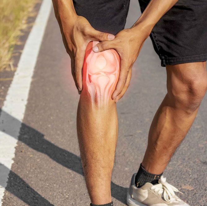 Glowing, transparent view of a human foot showing bones and joints, highlighted in pink and red.