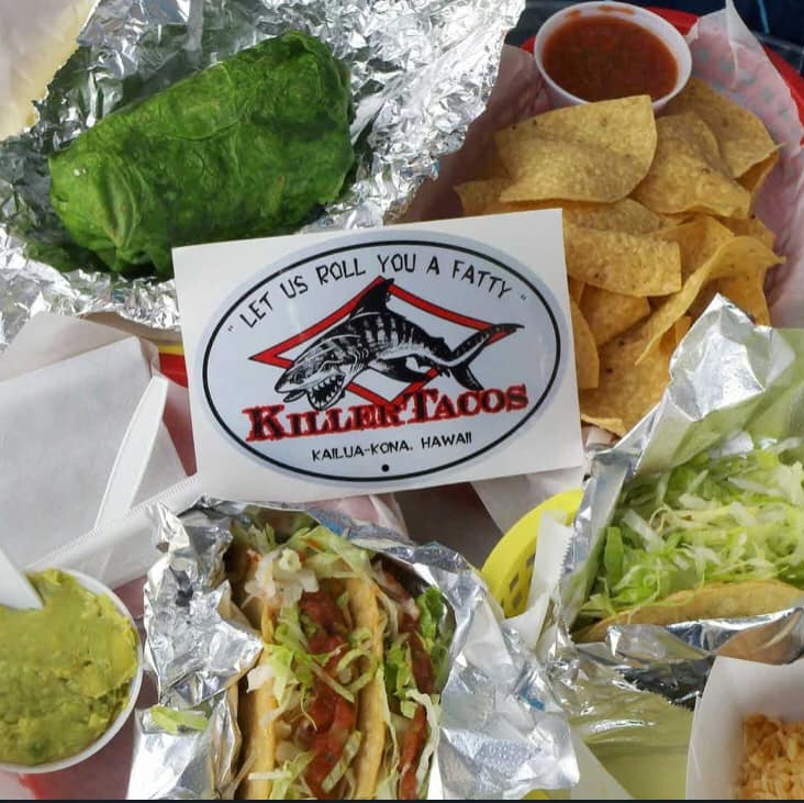 Killer Tacos takeout: tacos, burrito, chips, salsa, guacamole, and a sticker.