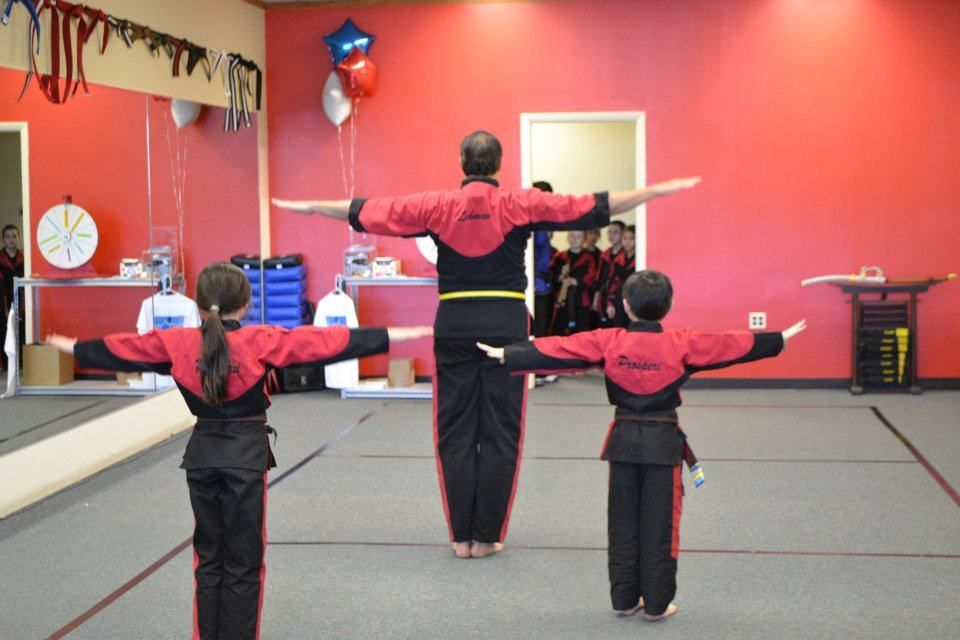 A group of people are practicing martial arts in a gym
