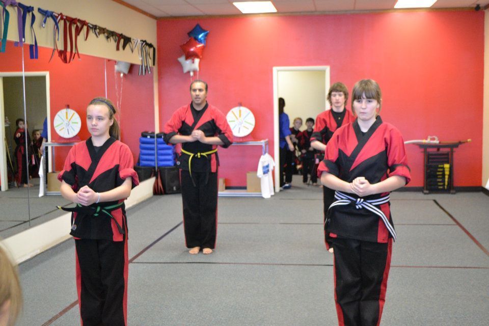 A group of people are practicing martial arts in a gym