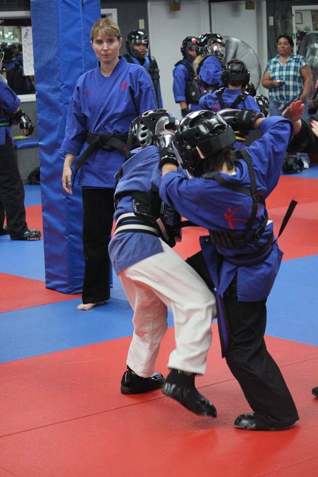 A group of people are practicing martial arts in a gym