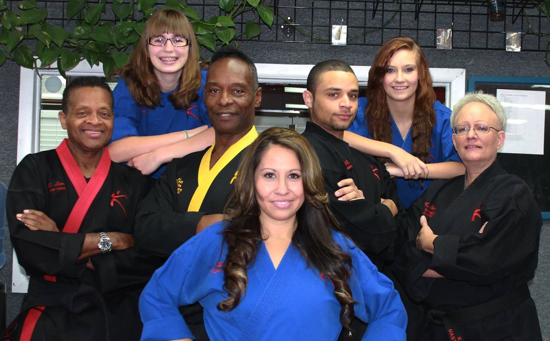A group of people in karate uniforms pose for a picture
