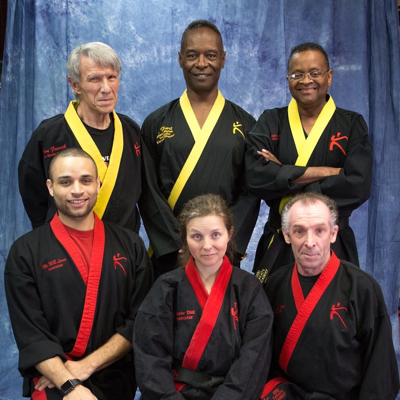 A group of people wearing black and red kimonos with the letter k on them