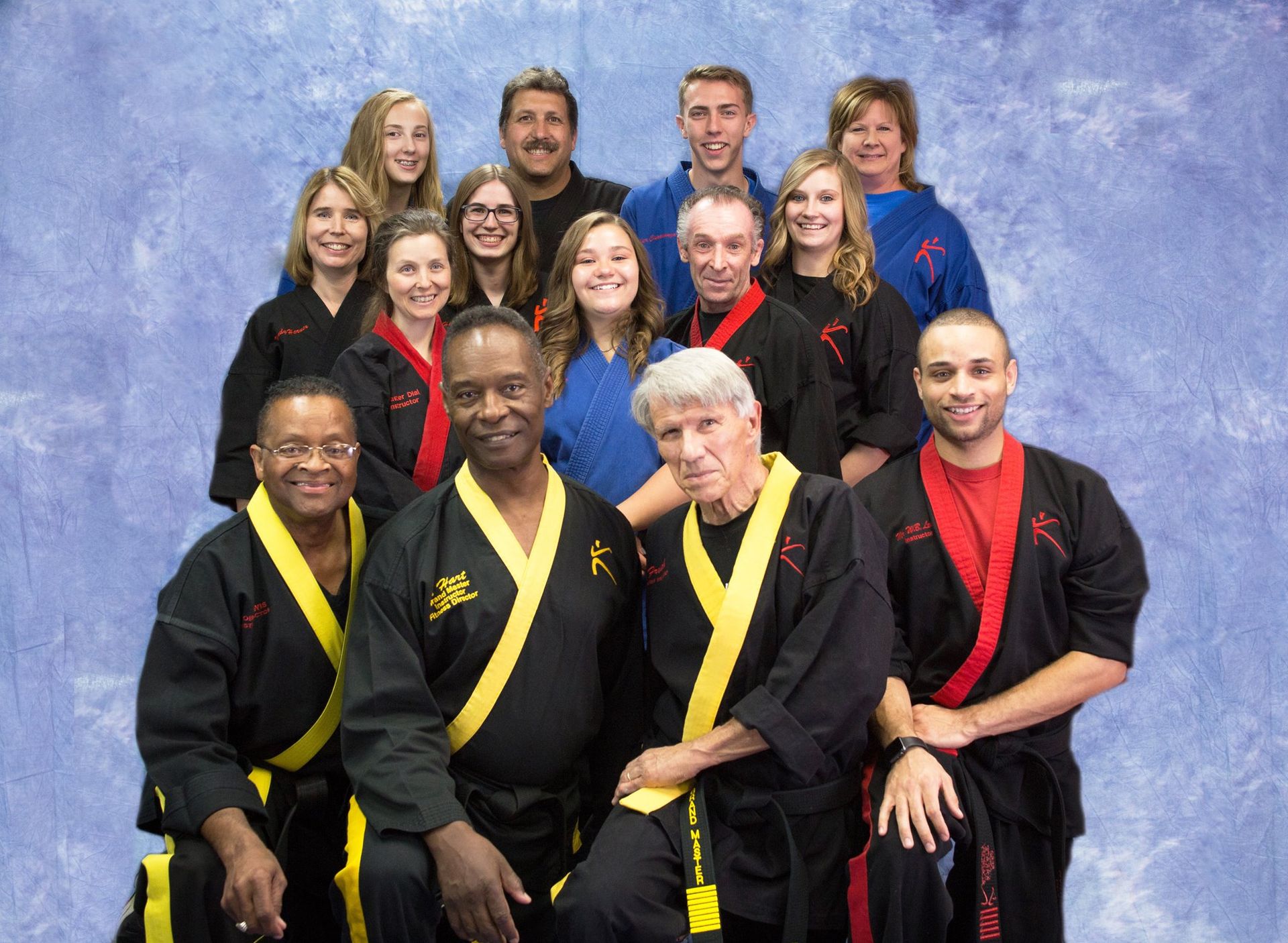 A group of people in karate uniforms pose for a picture