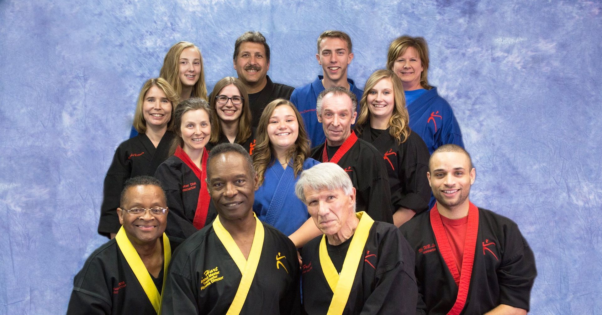 A group of people in karate uniforms are posing for a picture.