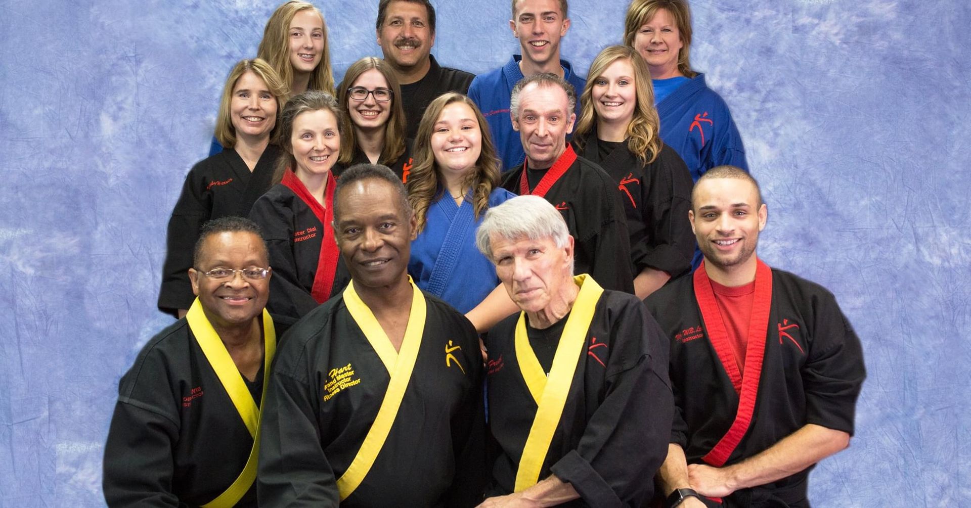 A group of people in karate uniforms are posing for a picture.