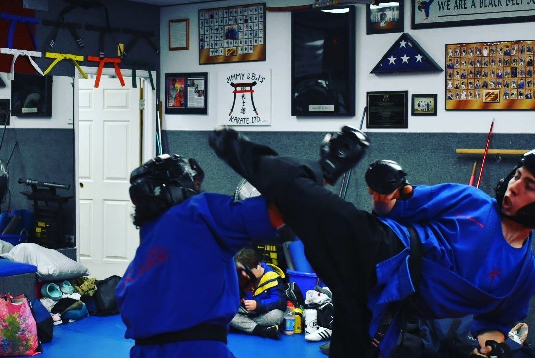A group of people are practicing martial arts in a gym