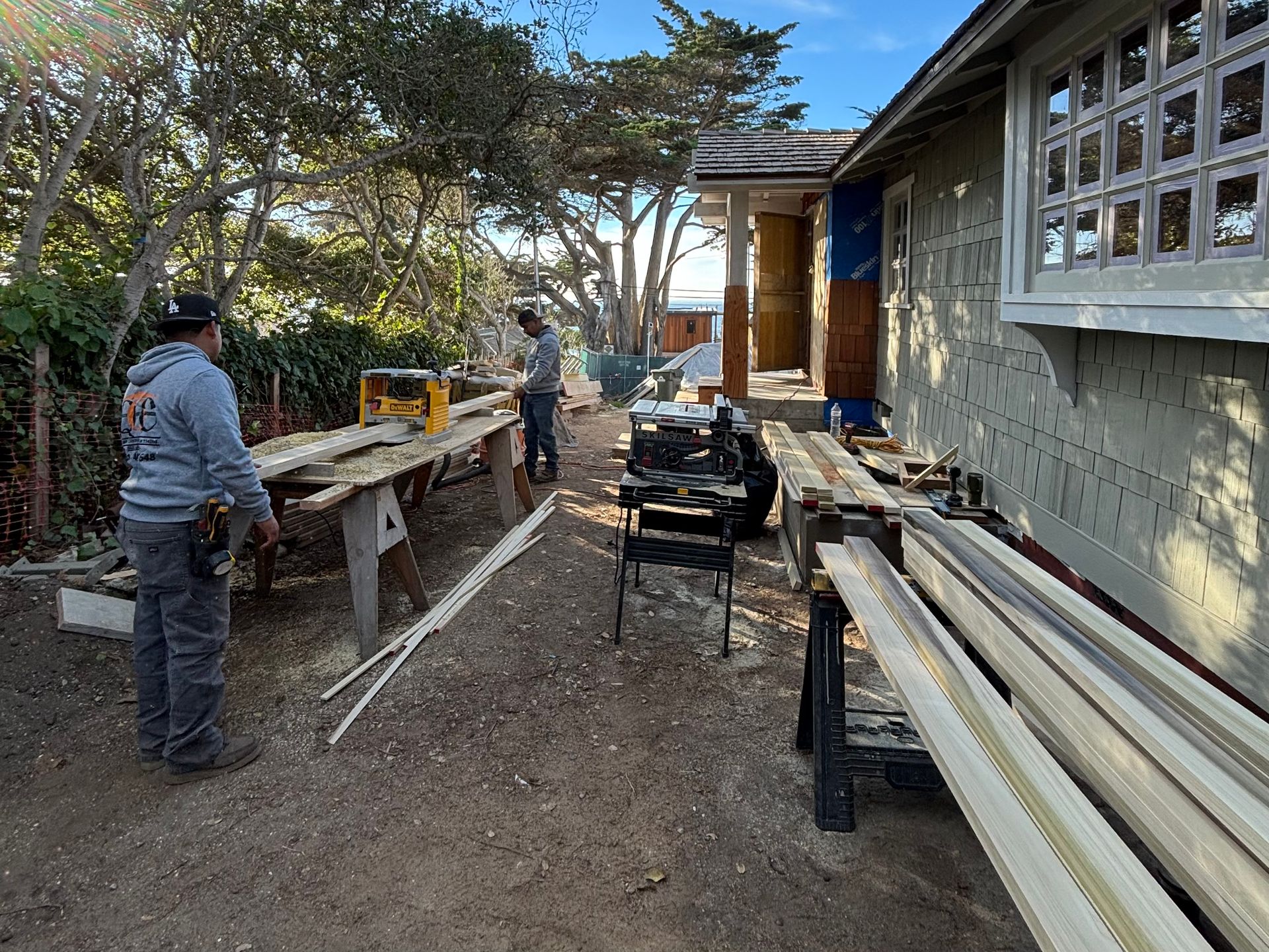 A ladder is sitting in front of a house under construction.