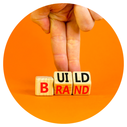 A hand is holding wooden blocks that say ui ld brand