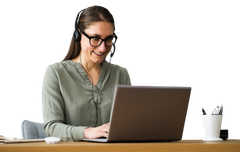 A woman wearing a headset is sitting at a desk using a laptop computer.