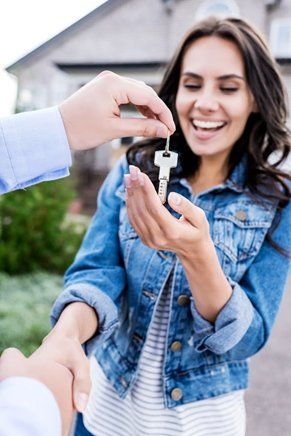 Happy Woman With A Key — Asheville, NC — Cornerstone Residential Mortgage