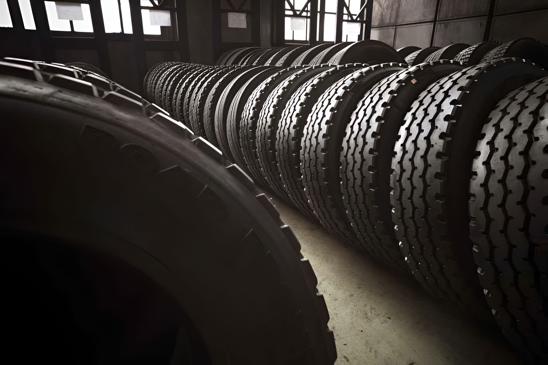 Rows of Black Tires Stacked in a Warehouse — Innisfail Pro Motors in Tablelands, QLD