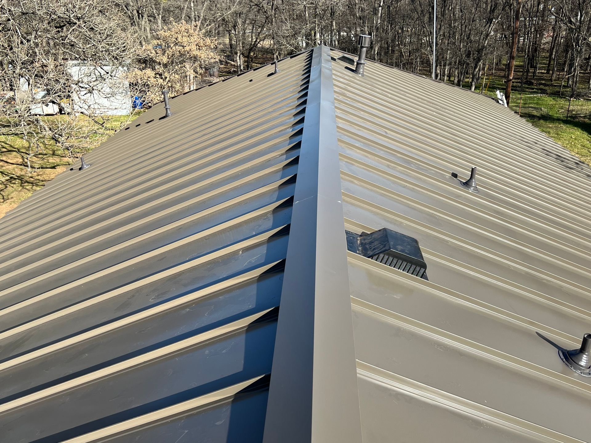 A close up of a metal roof with a gutter on it.