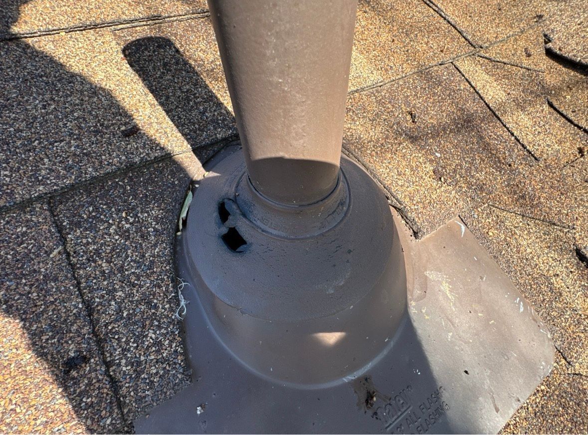 A chimney on the roof of a house with a blue sky in the background.