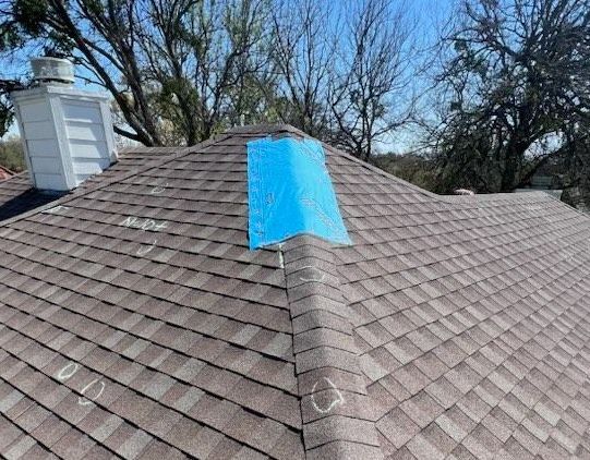 A roof with a piece of blue tape on it.