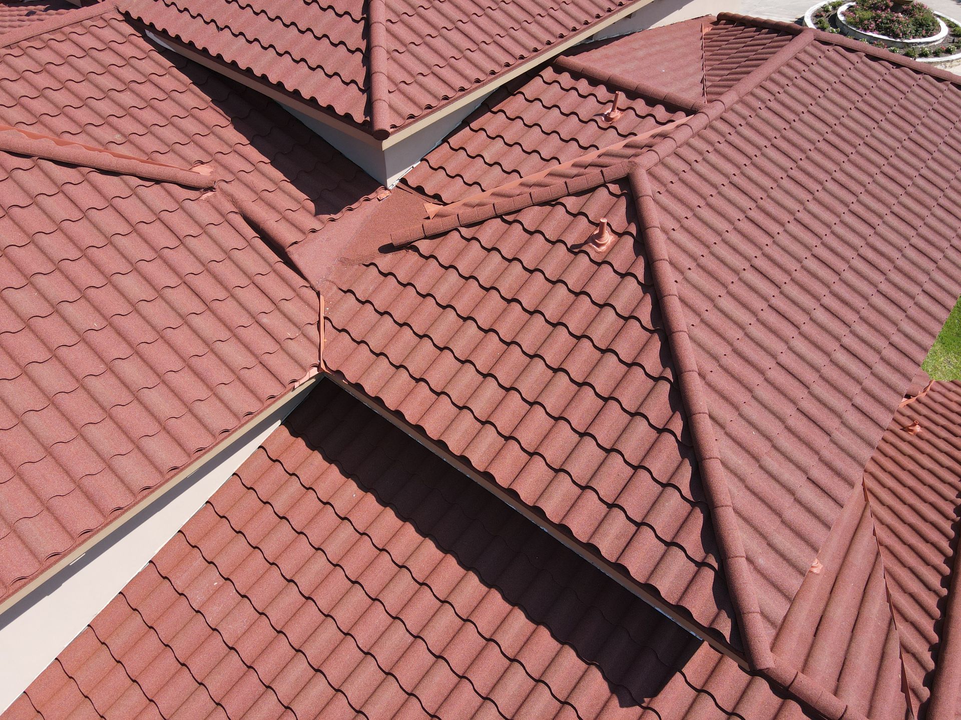 A white house with a green window and a blue sky in the background