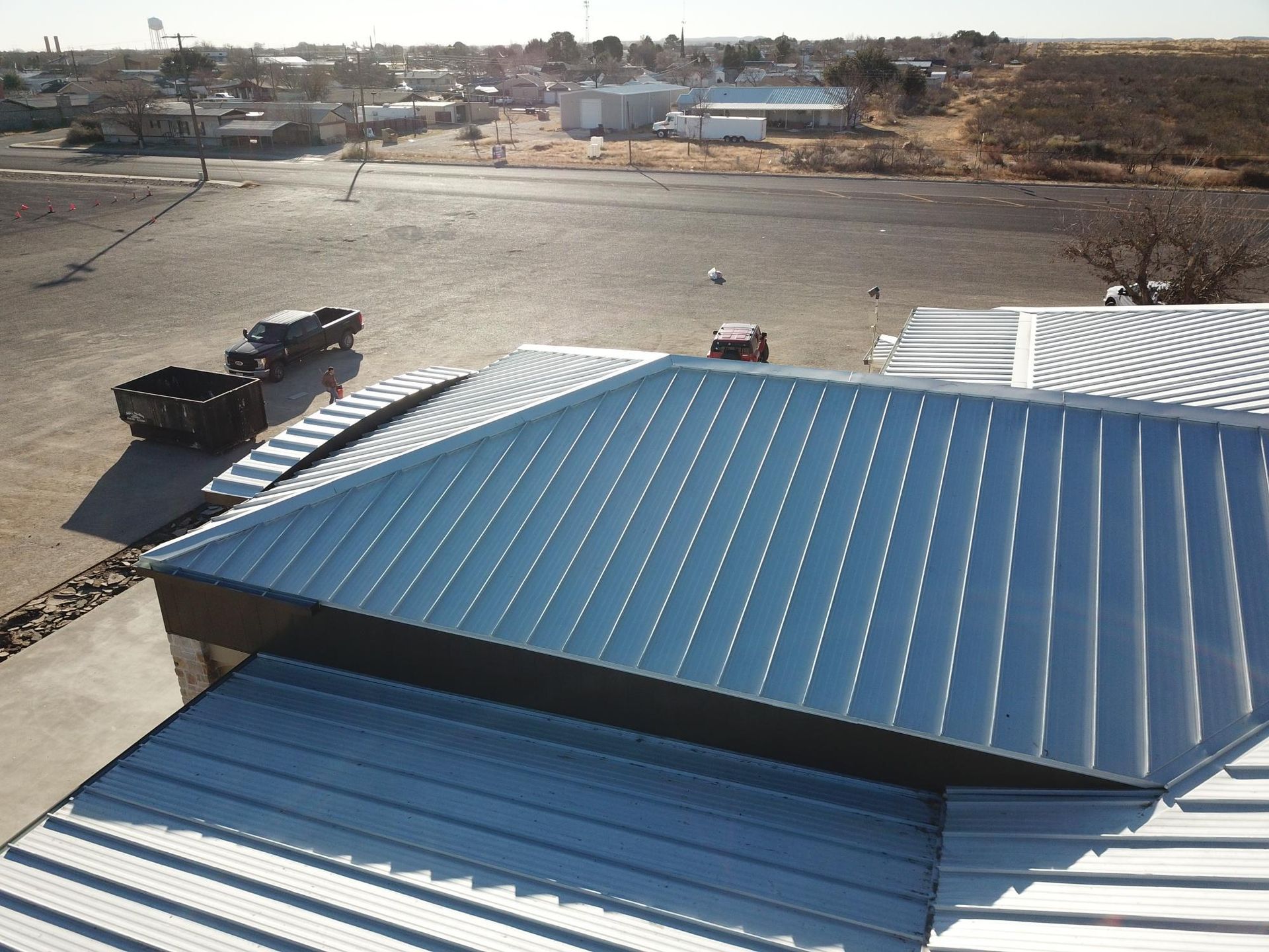 An aerial view of a building with a blue roof