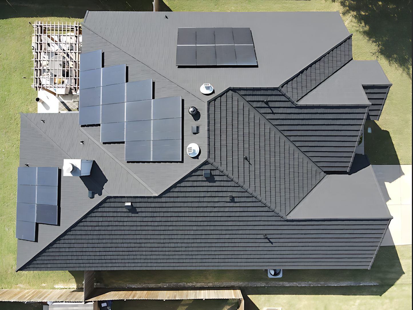 An aerial view of a house with solar panels on the roof
