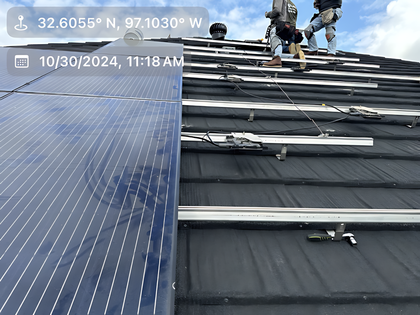 Solar panels are being installed on the roof of a building