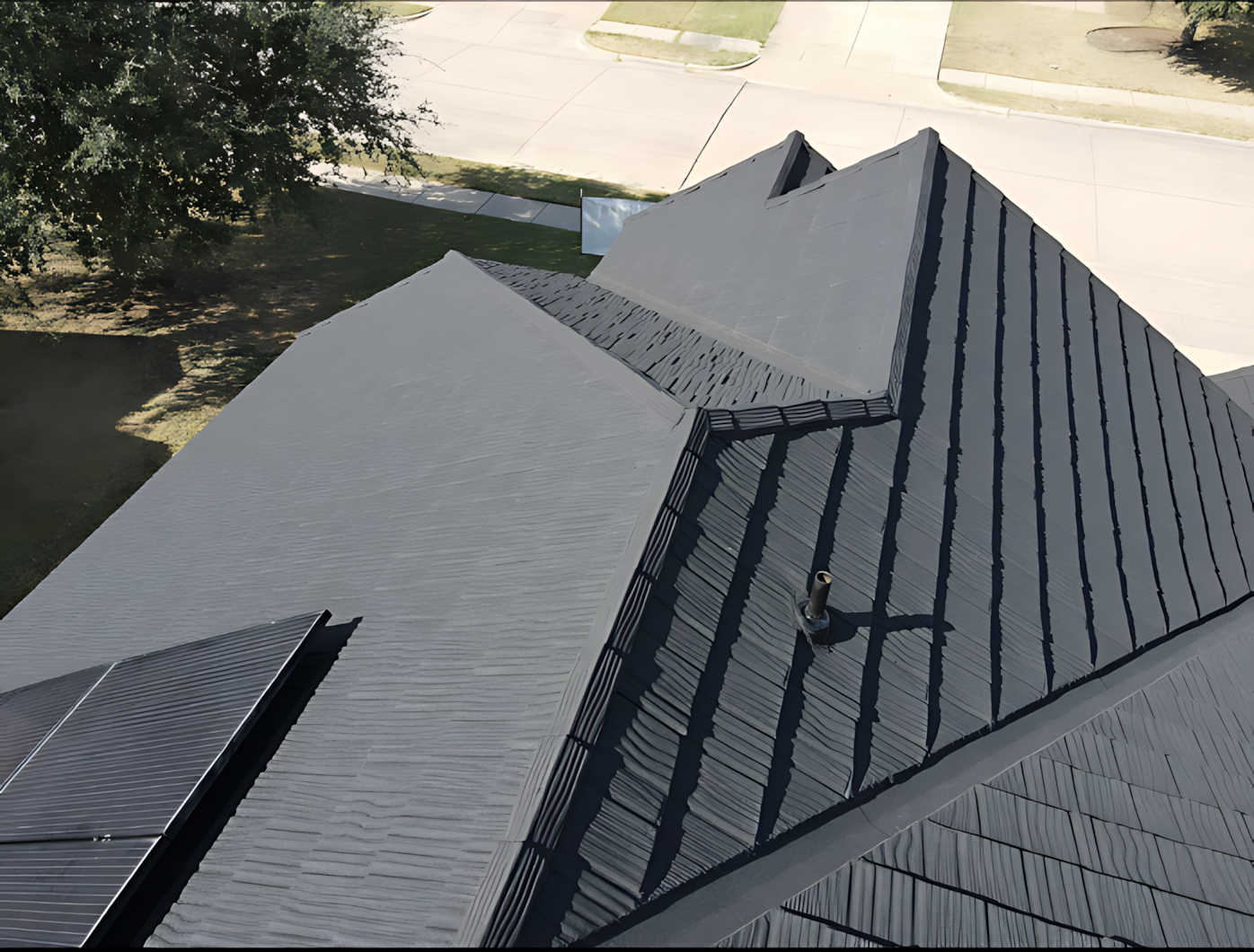 An aerial view of a house with a black roof