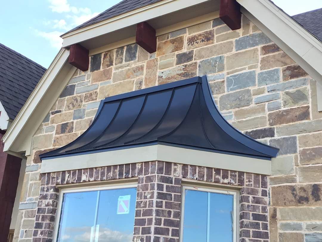 A brick building with a blue awning over a window