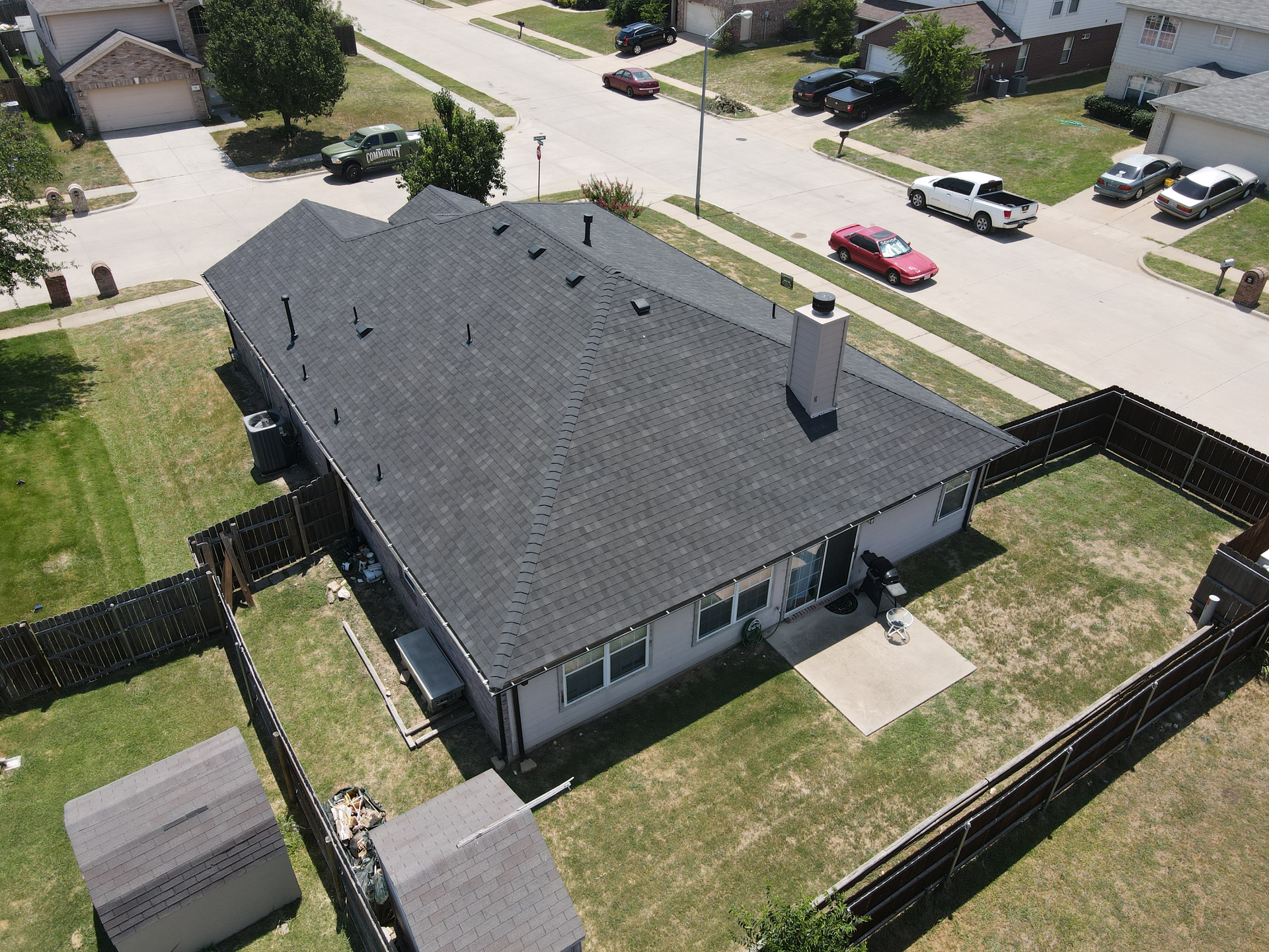 An aerial view of a house with a black roof