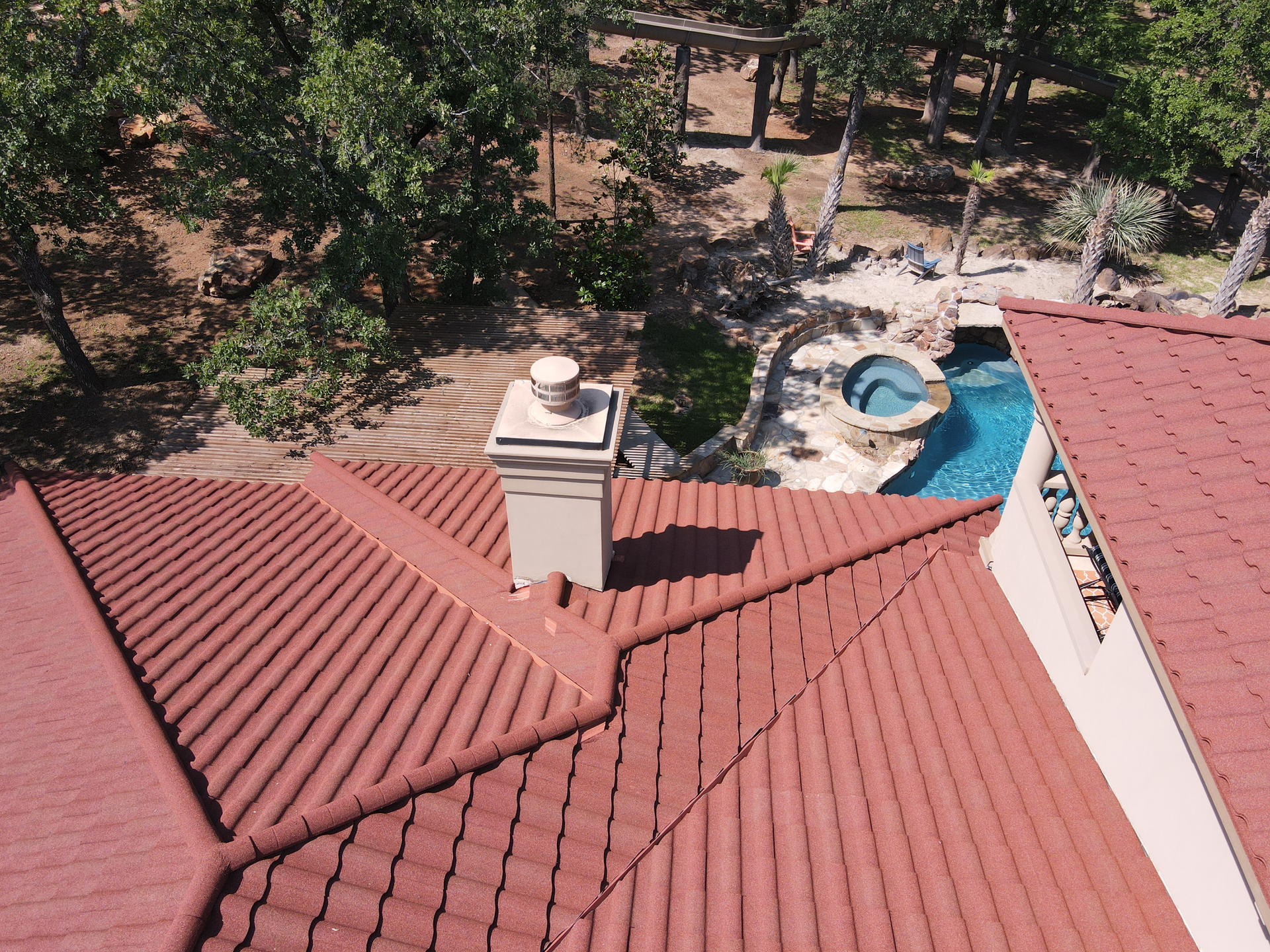 An aerial view of a house with a red tiled roof