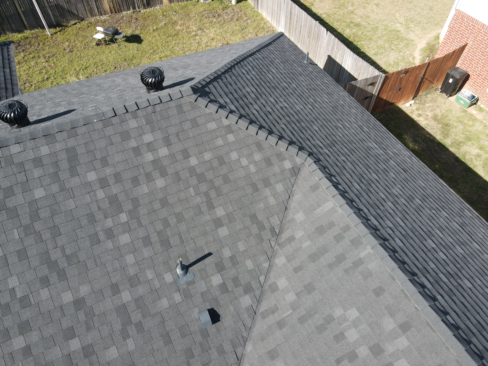 An aerial view of a roof with a roof fan on it