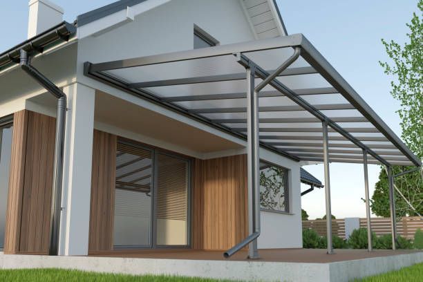 Modern dark grey metal patio awning attached to house.