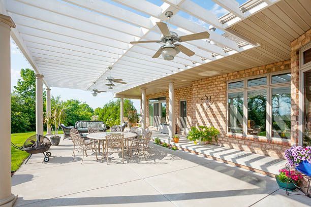 White lattice patio cover over outdoor dining area.