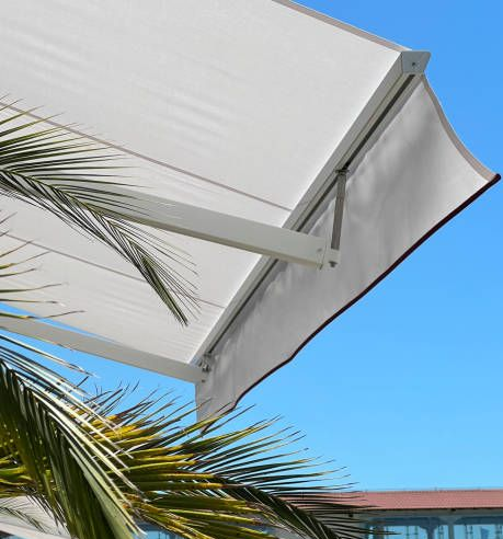 Close-up of a retractable white motorized fabric awning.
