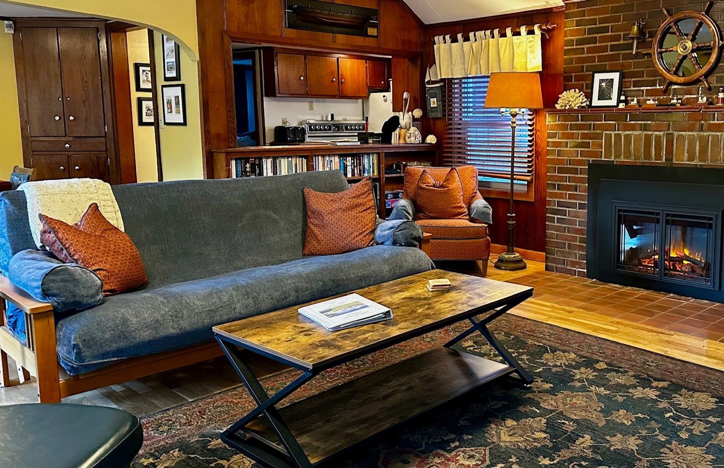 A living room with a couch , coffee table and fireplace.