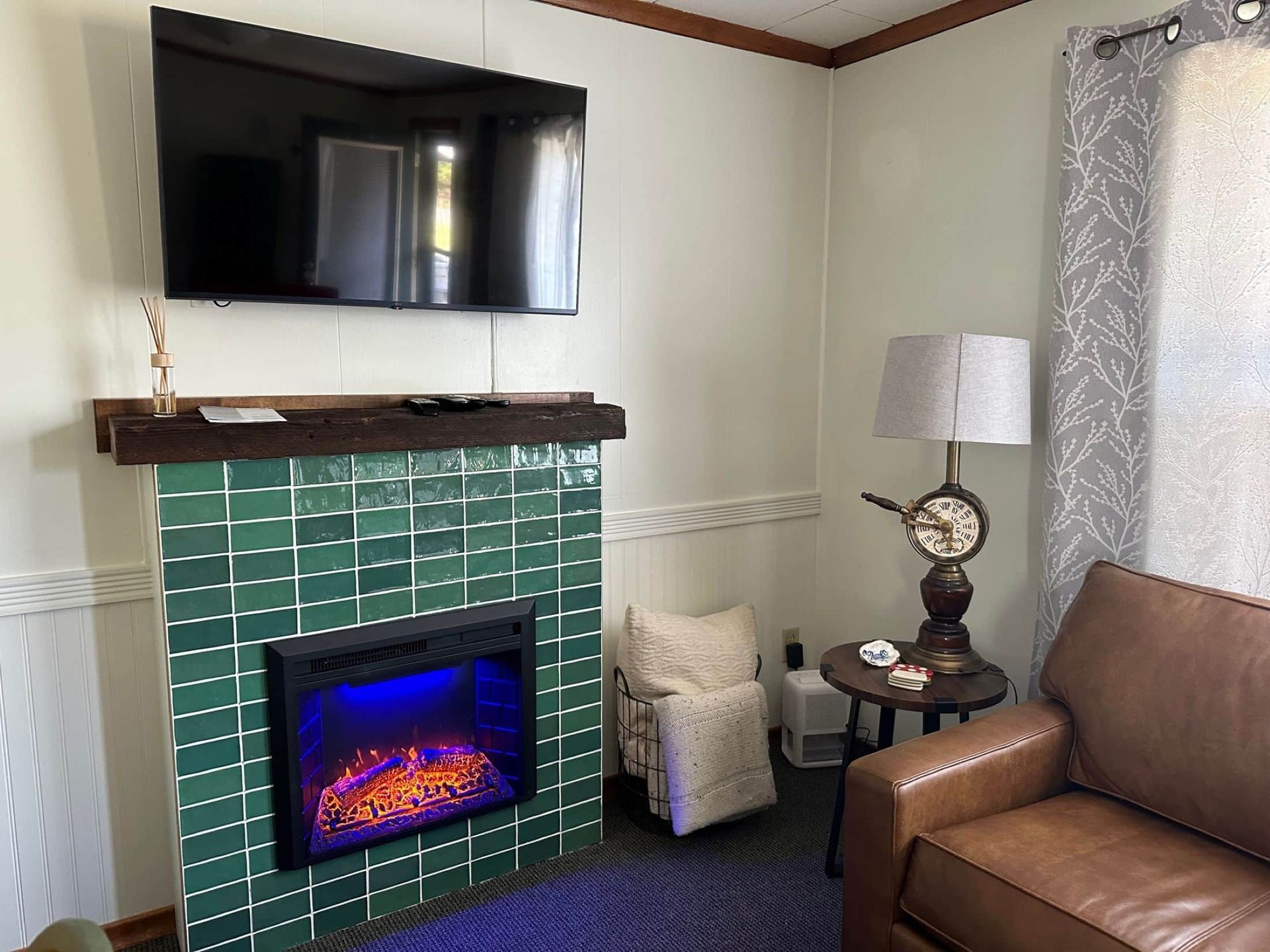 A living room with a fireplace and a flat screen tv.