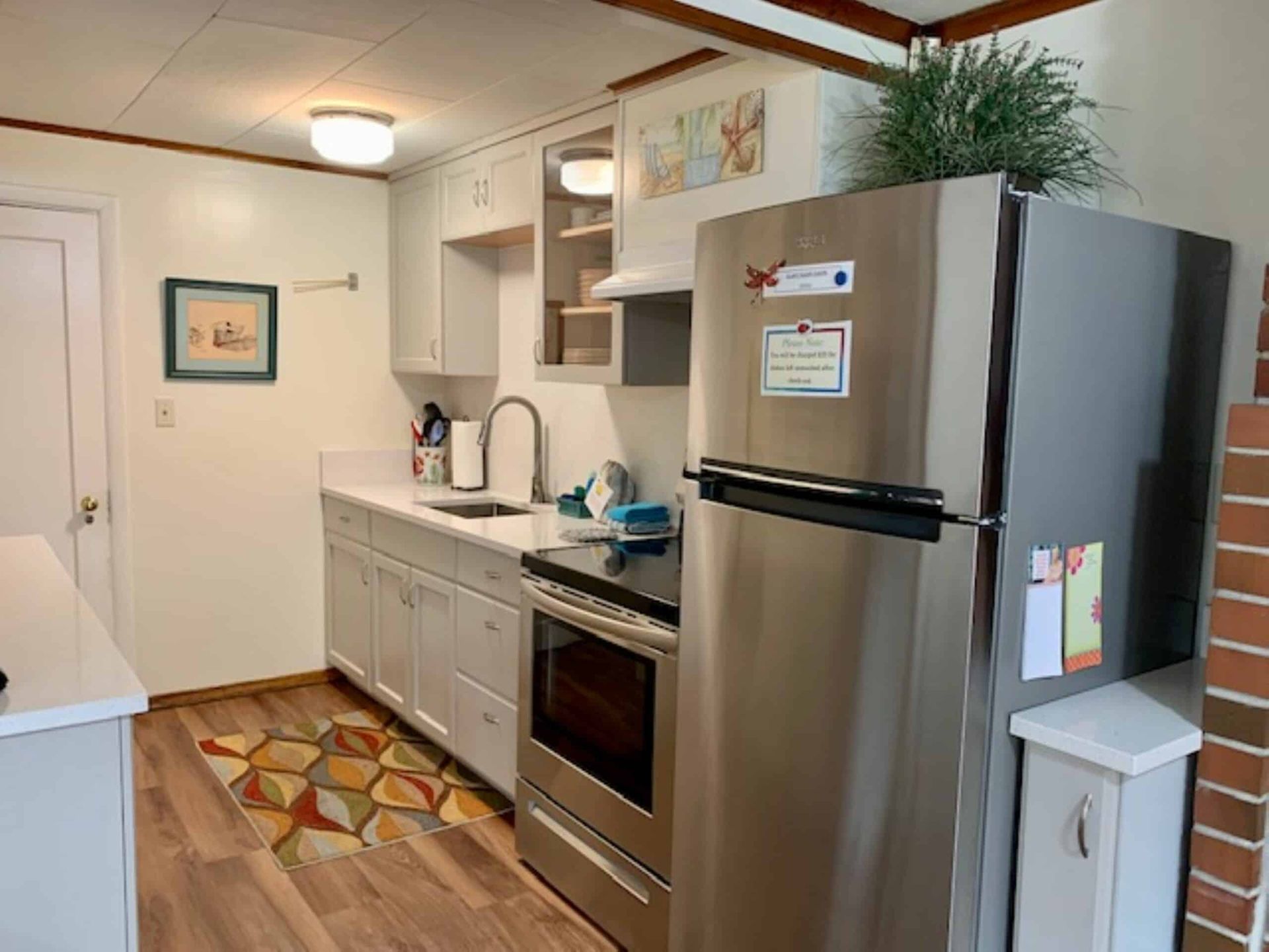 A kitchen with stainless steel appliances and a stainless steel refrigerator.