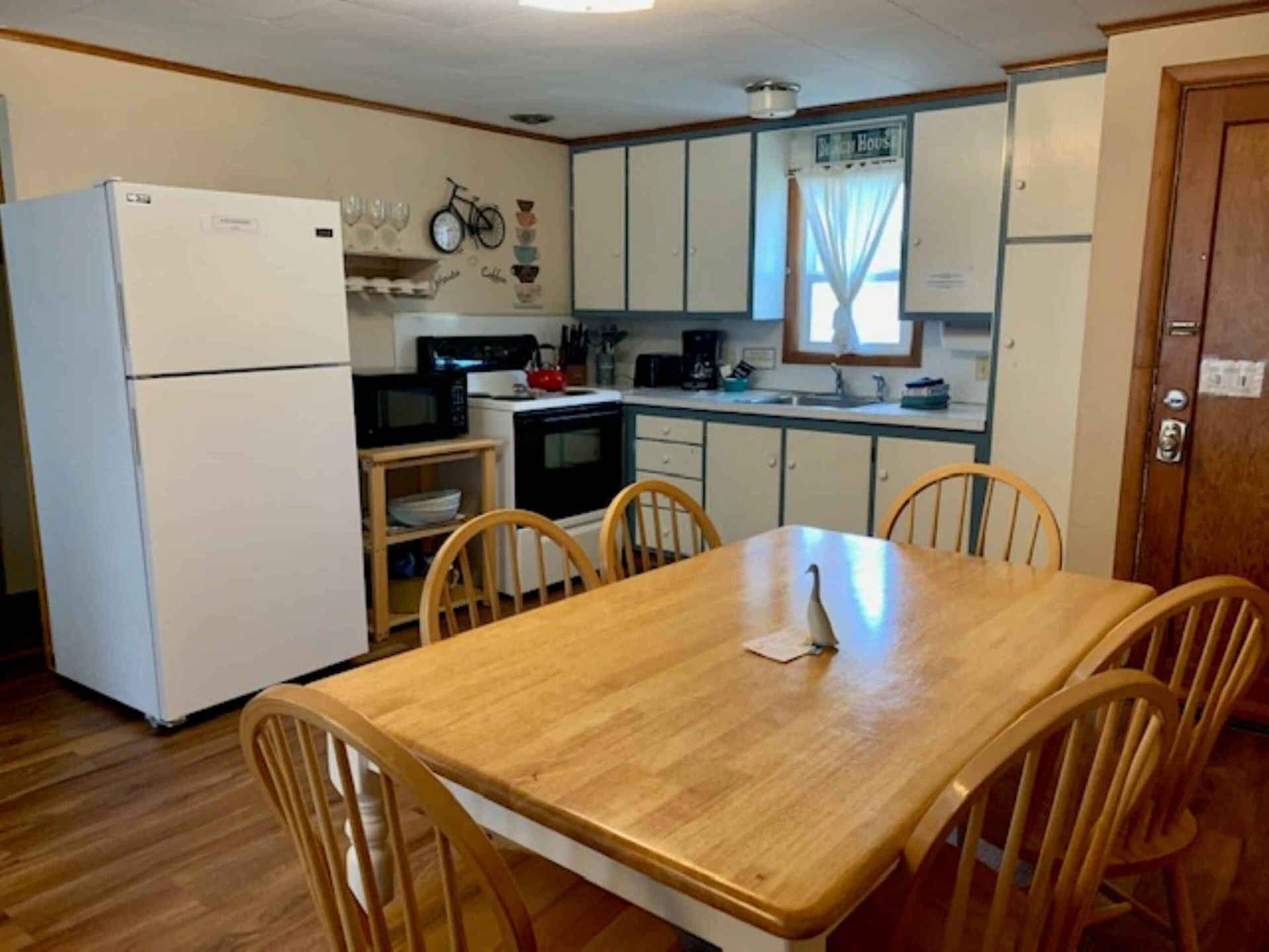A kitchen with a table and chairs and a refrigerator
