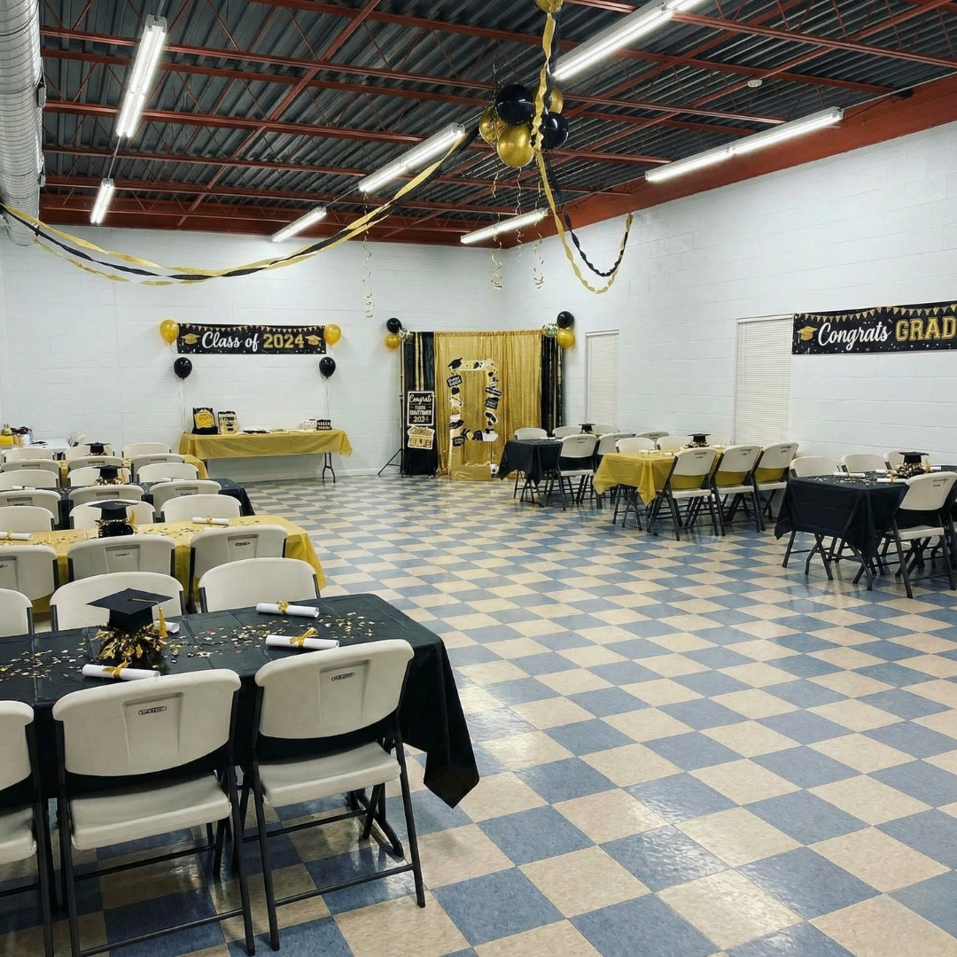 Graduates in black gowns toss graduation caps into a bright blue sky.