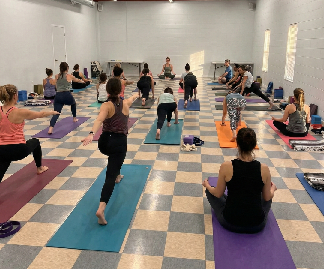 Man in suit speaks at a podium. Two people sit behind a desk with a European Union flag. Audience members in chairs.