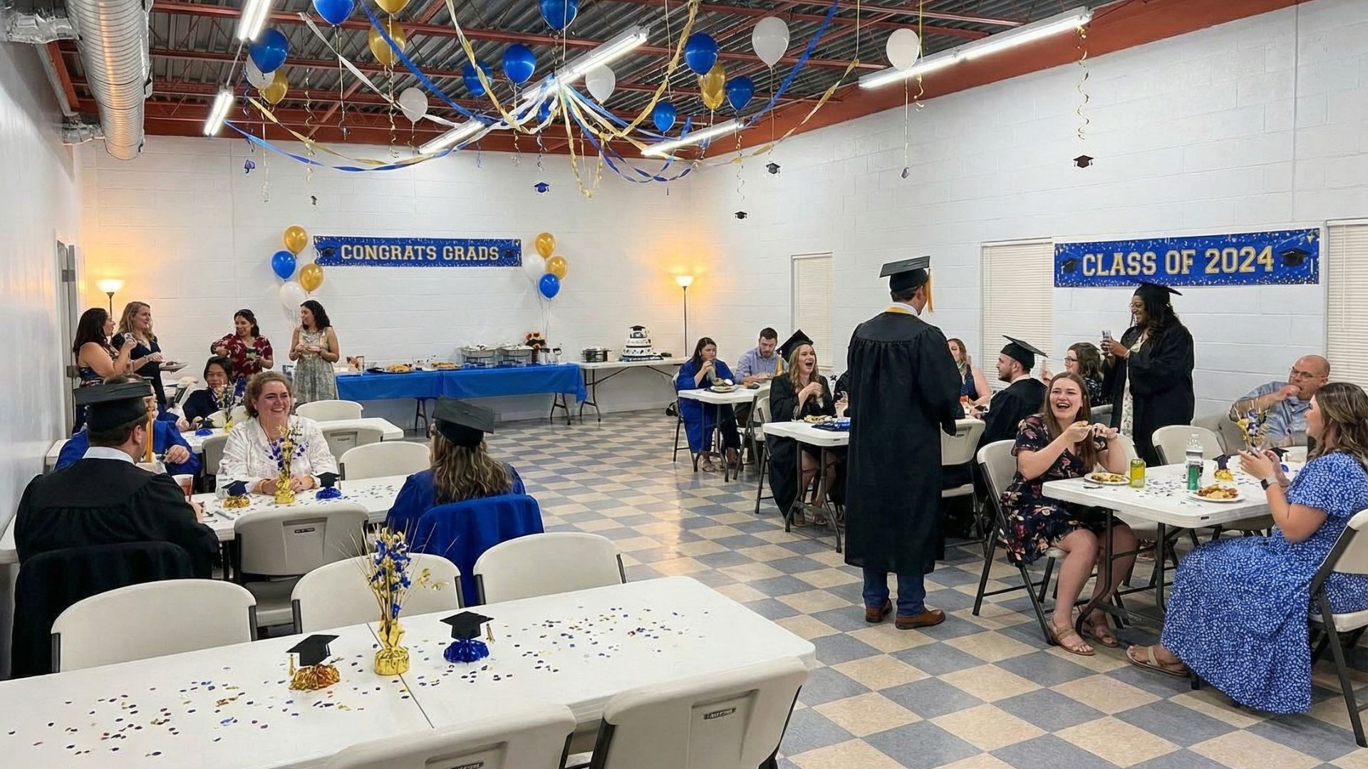 Graduates in black gowns toss graduation caps into a bright blue sky.
