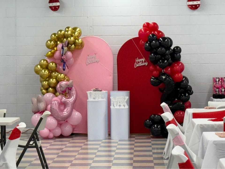 Dog lounging on confetti near gold balloons that spell